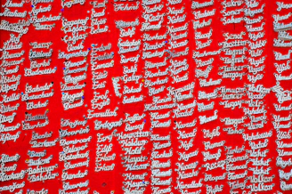 Close-up of colorful silicone nameplates arranged neatly on a display board.