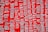 Silver nameplate necklaces are displayed against a vibrant red background. Each necklace is pinned individually and features a variety of names in a cursive style.