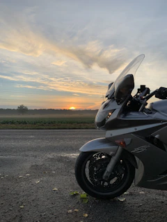Motorbikes lined up against a mountain backdrop at sunrise, ready for the day.