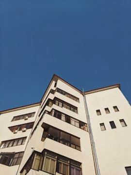 low-angle photography of white high-rise building