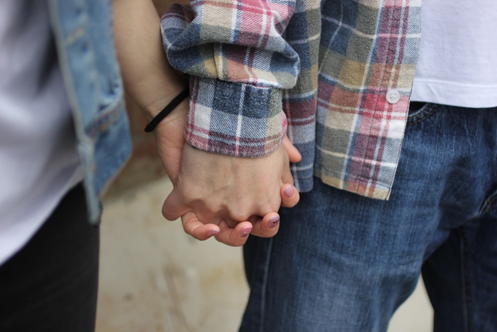 couple holding hands selective photography