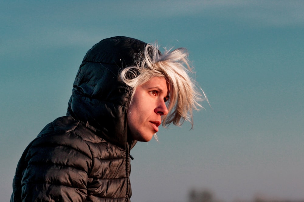 man wearing black hooded puffer coat