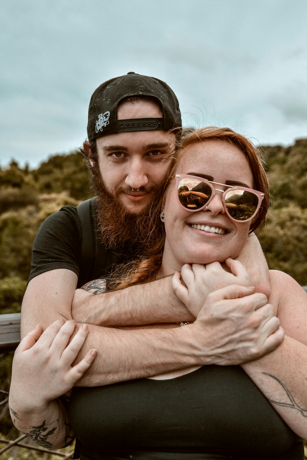 man hugging a woman while on her back