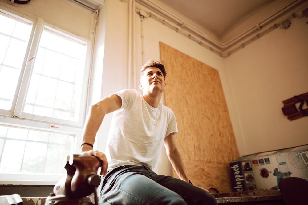 man sitting on wooden bench