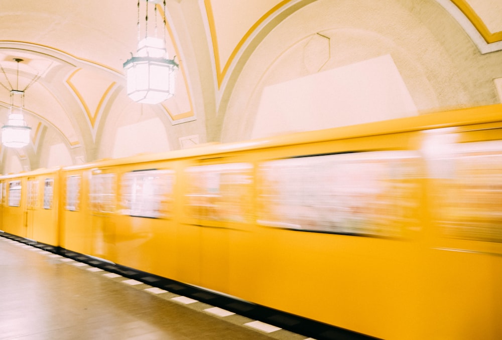 panning photography of yellow train