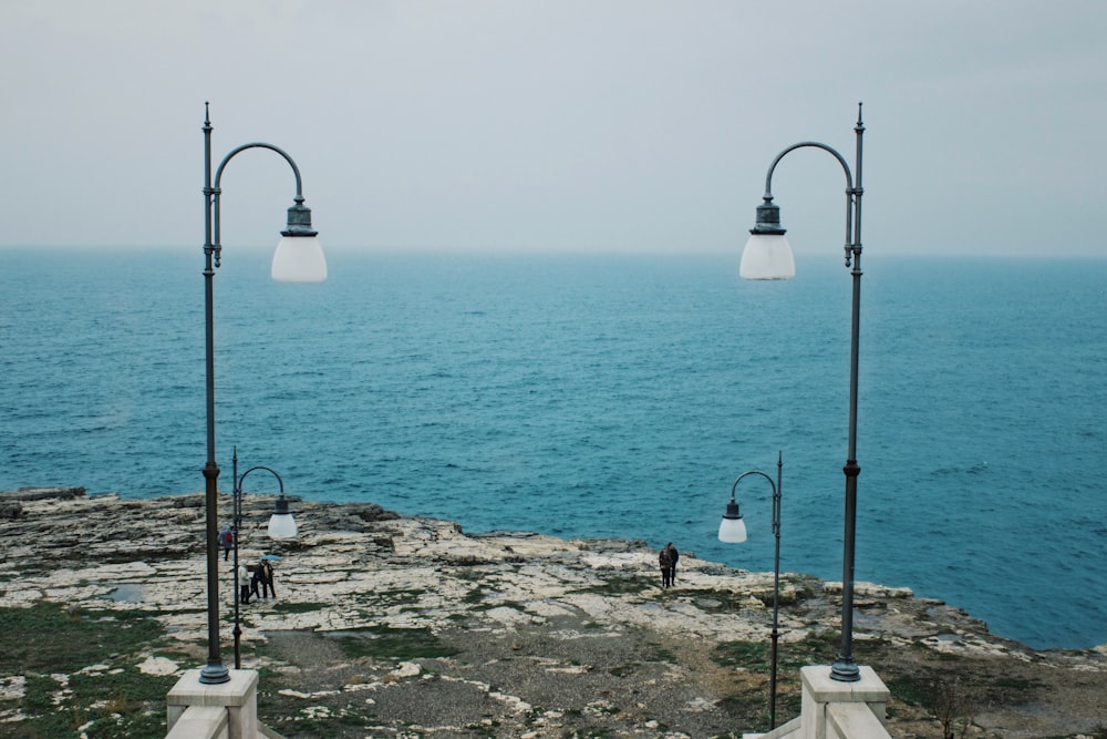 turned-off post light near body of water