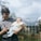 man in grey polo shirt holding baby