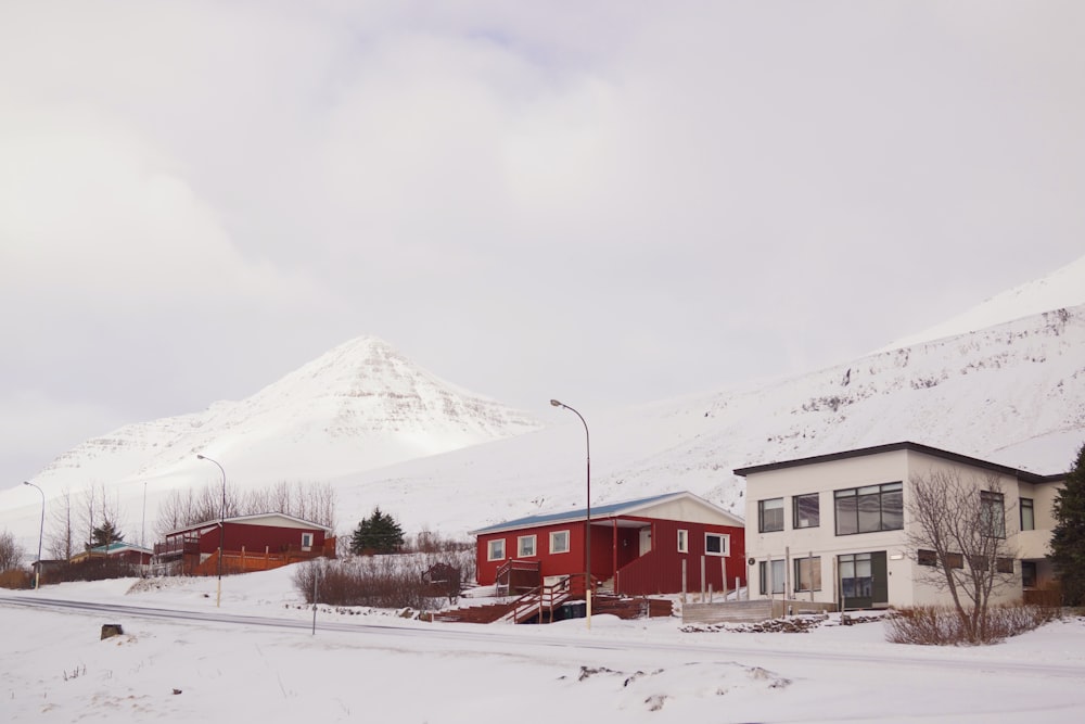 snow covered road surrounding buildings during daytime