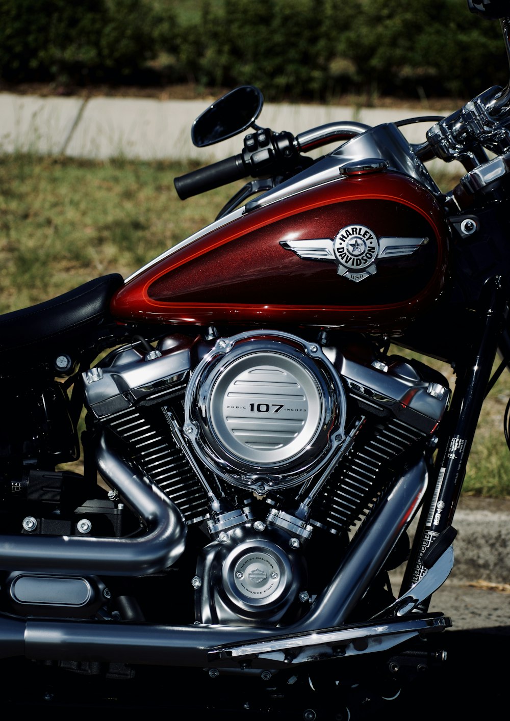 parked red and gray 107 cruiser motorcycle during daytime