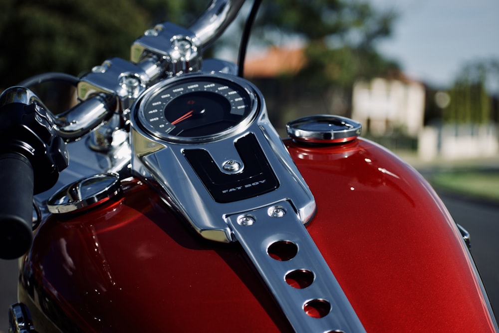 a close up of a red motorcycle with a speedometer