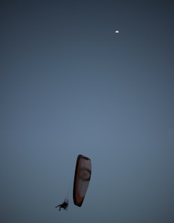 Instructor guiding a student during a night flying practice under clear skies.