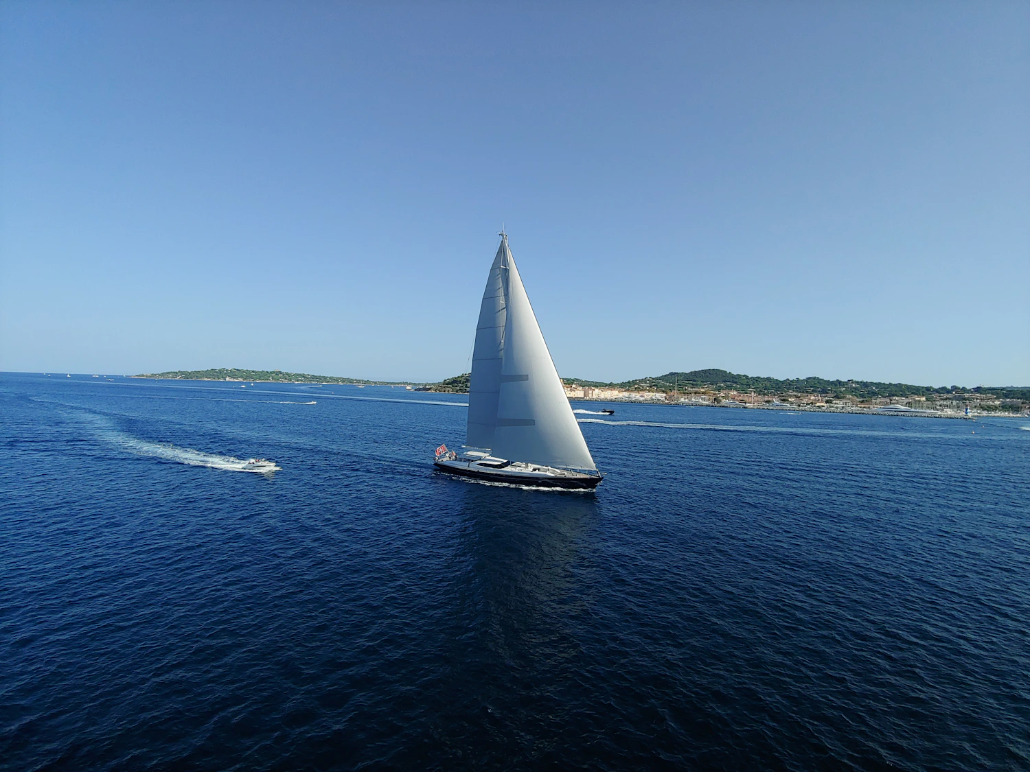 A luxury sailboat gliding across the blue Mediterranean Sea