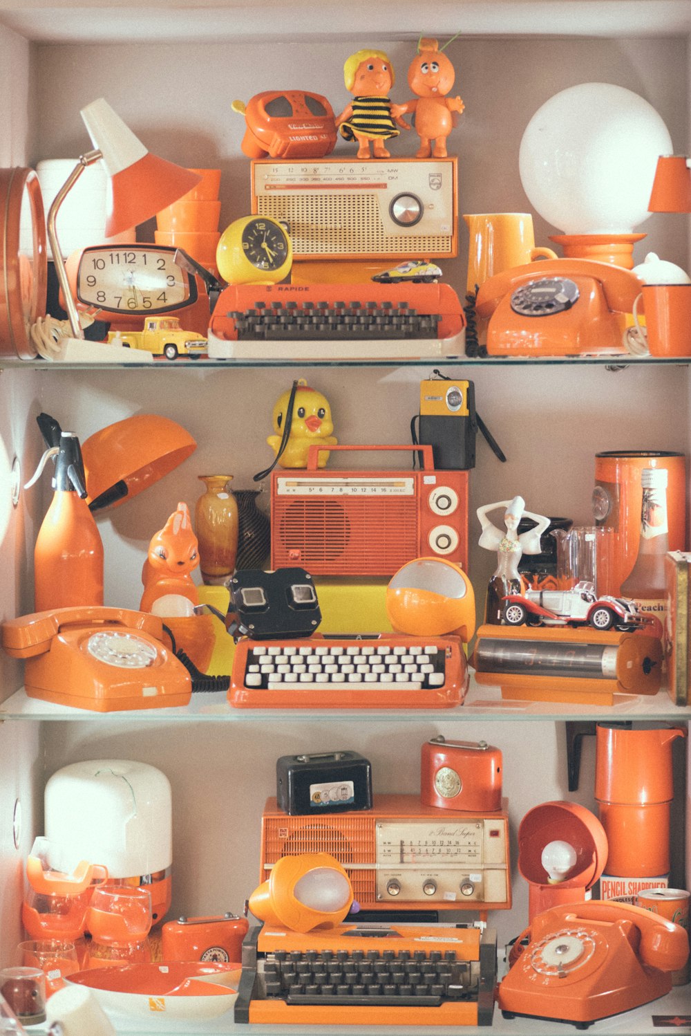 assorted orange appliances lot on display
