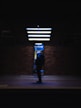 a person with a backpack is standing in the dark