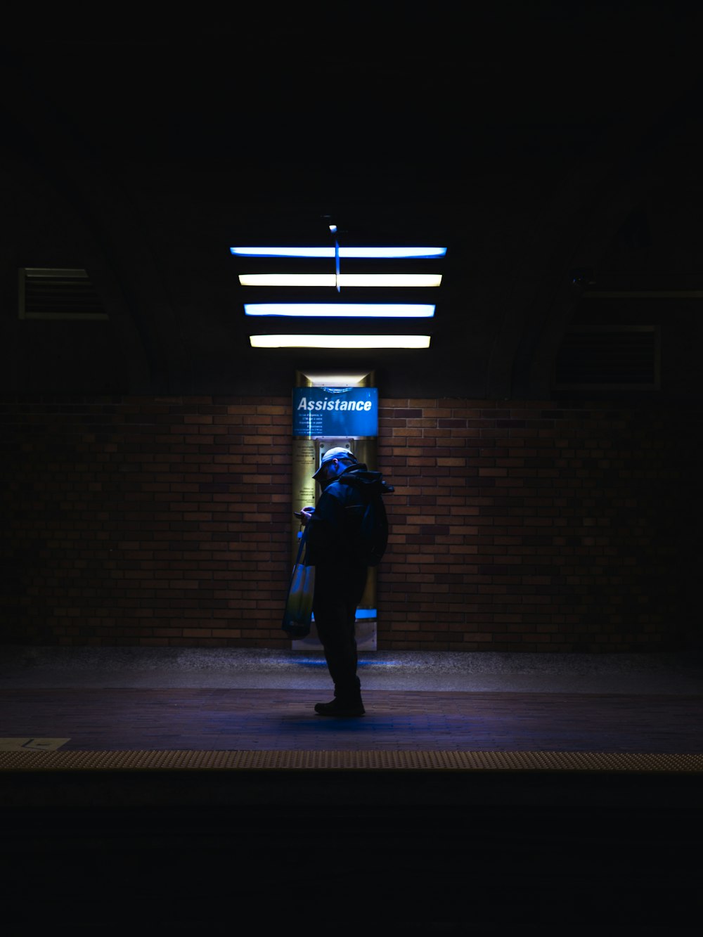 a person with a backpack is standing in the dark