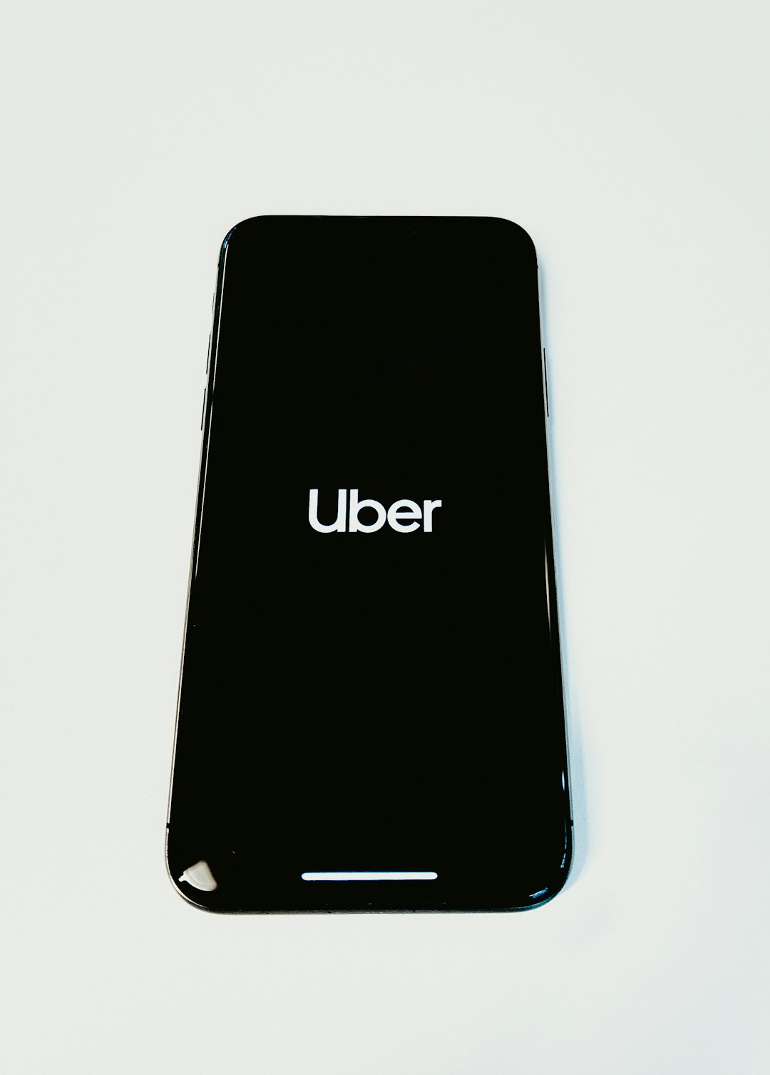 black Uber smartphone on white surface