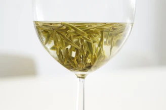 green flower petals in clear glass goblet