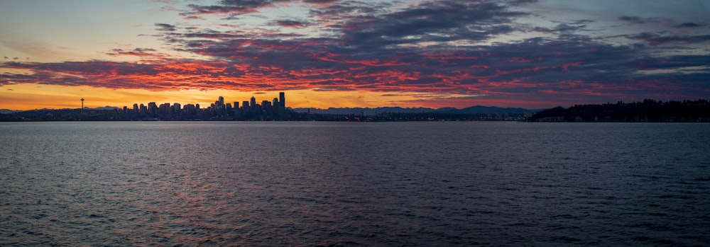 high-rise buildings viewing calm sea during sunset