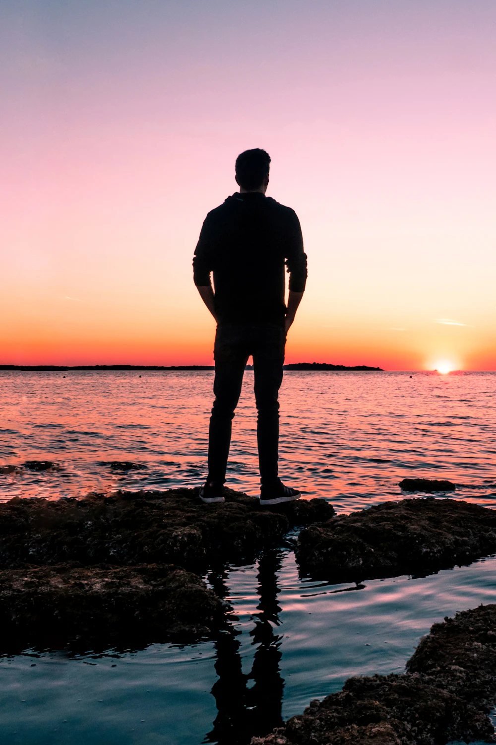 Man reflecting alone at sunrise