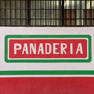 A warm, inviting bakery storefront with the panalcuadrado sign visible.