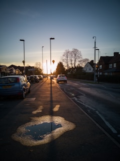 Sunset casting long shadows on a quiet suburban street during an evening run.