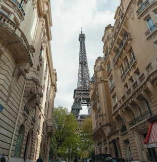 A scenic view of the Eiffel Tower with a vintage taxi parked nearby, capturing the essence of Parisian travel.