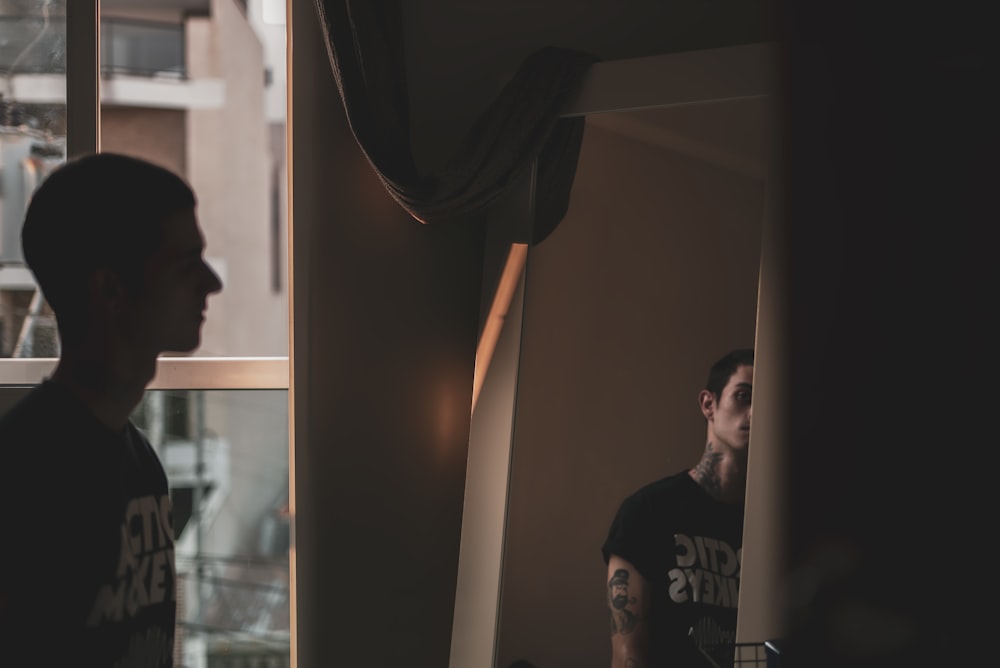 man watching in front of mirror