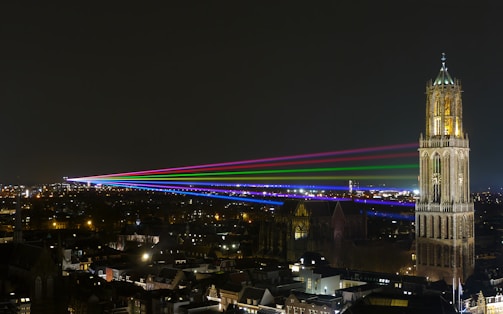 A captivating video still showcasing UFOs flying over a cityscape at night.