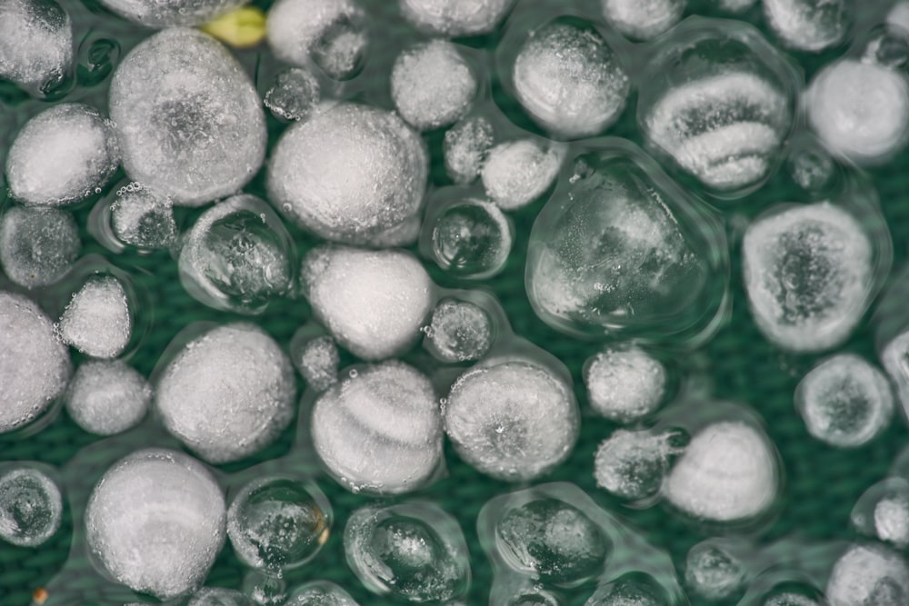 a close up of ice bubbles on a green surface