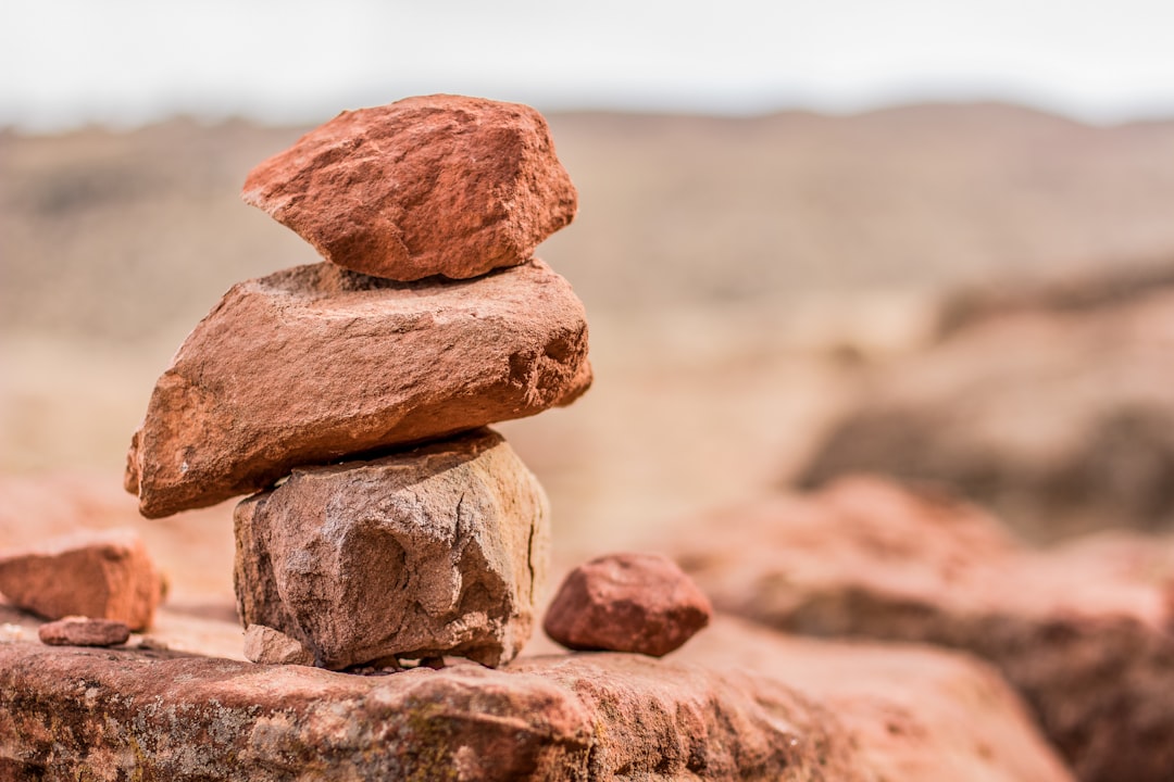 stacked brown rocks, pile of stones idyllic outdoor concept wallpaper background pattern with empty copy space for text 