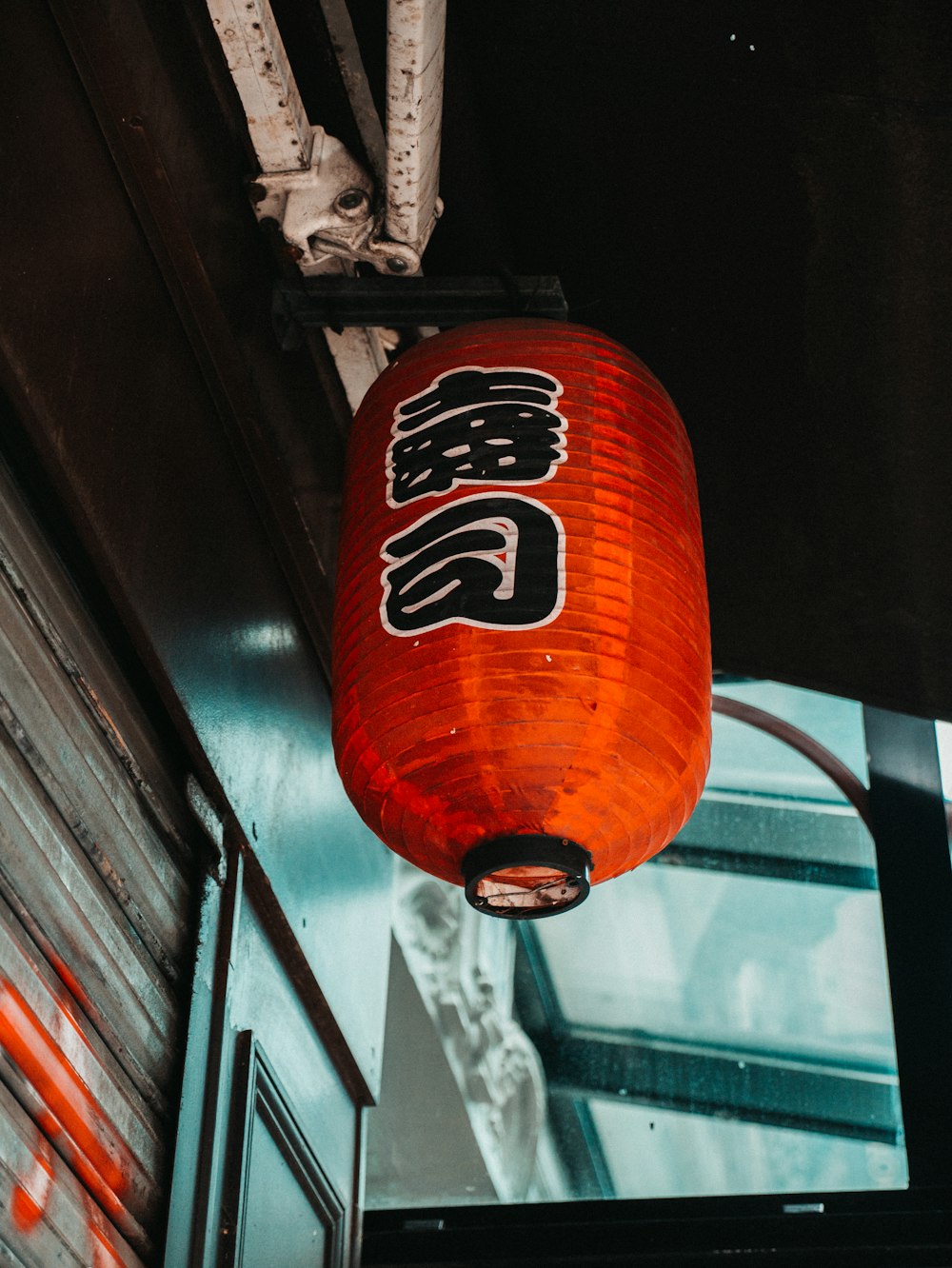 a red lantern hanging from the ceiling of a building