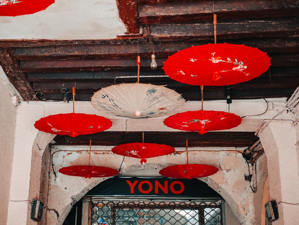 red and white opened umbrellas hanging on ceiling