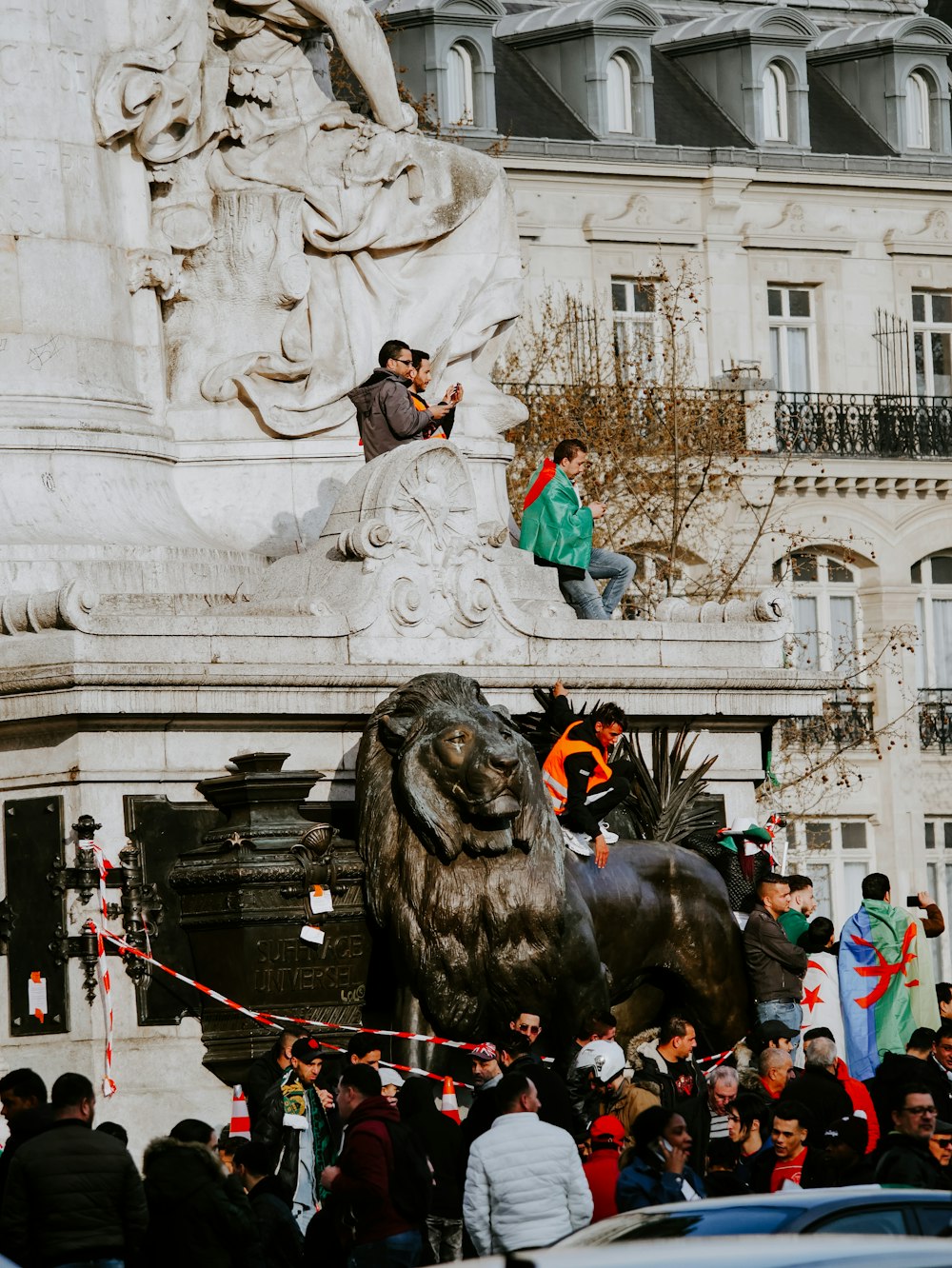 people standing near lion statue