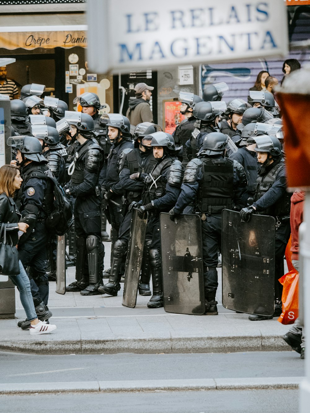 riot police on street during daytime