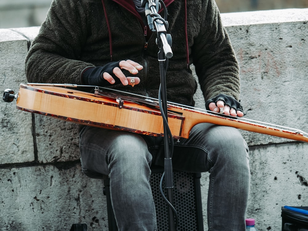 person playing guitar white singing