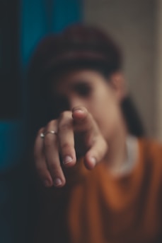 Close-up of a suspicious individual looking directly at the camera, with a blurred background suggesting secrecy.