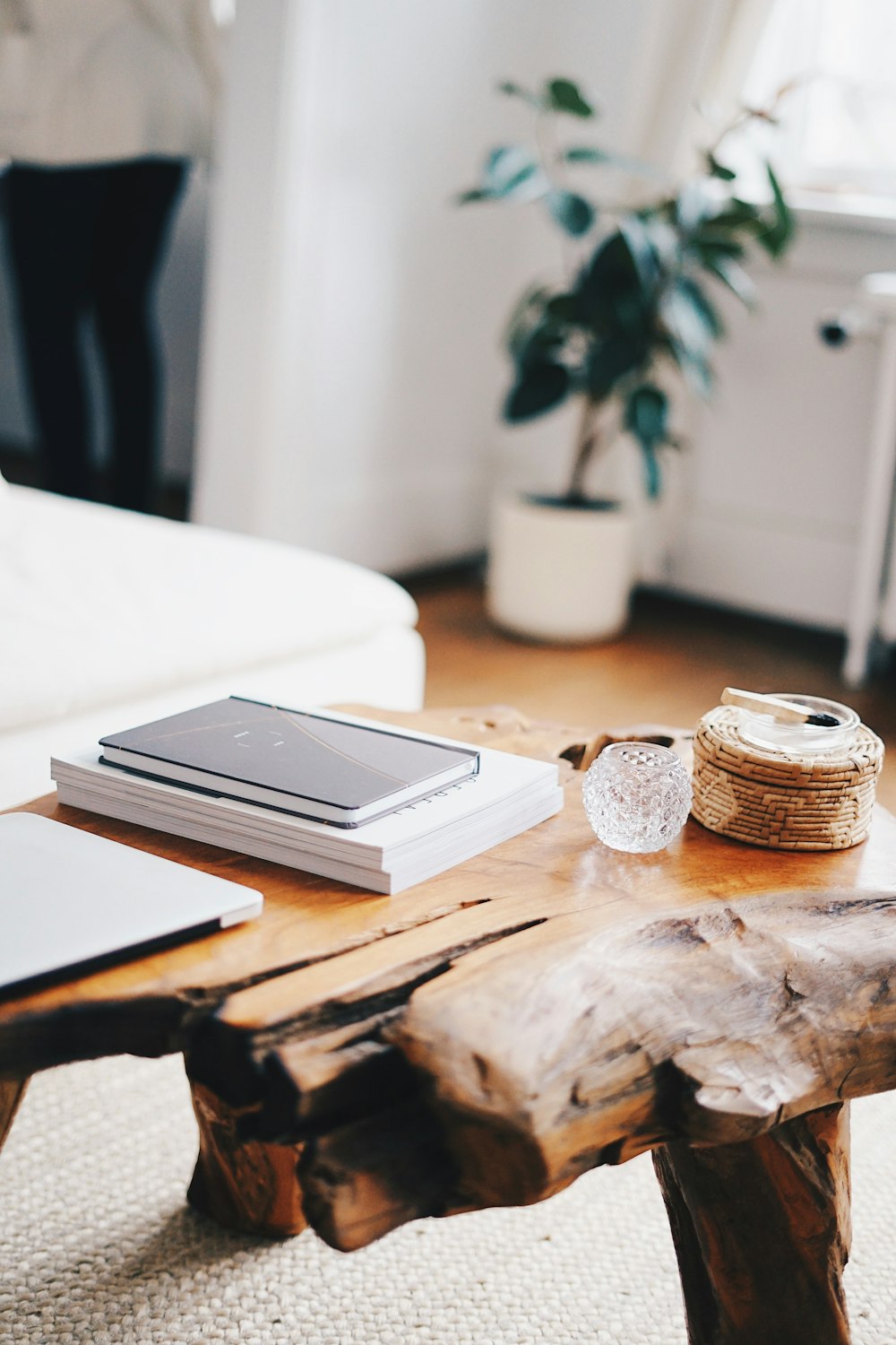 a wooden table with a laptop and a book on top of it