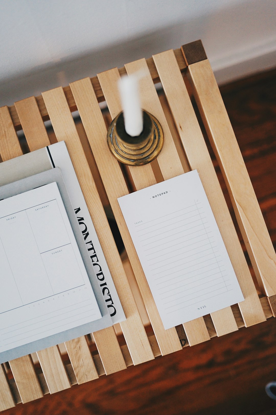 white printer paper beside brown candlestick