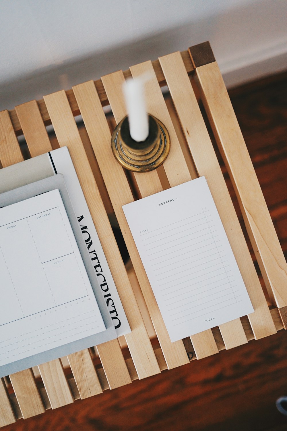 white printer paper beside brown candlestick