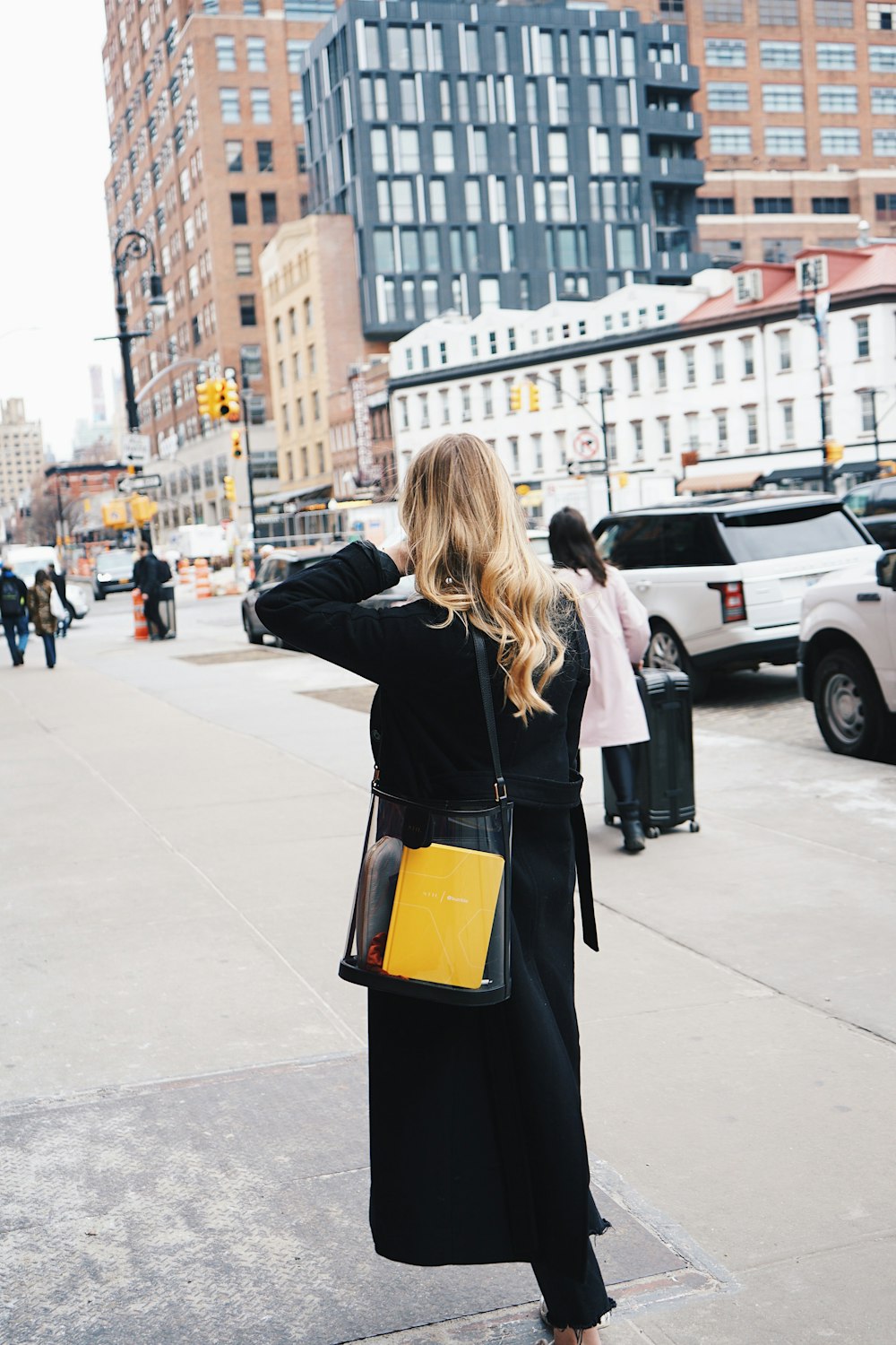 woman walking on sidewalk during daytime