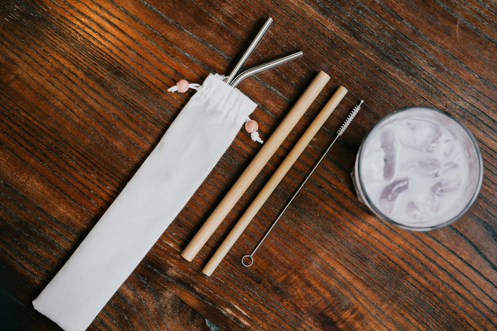 reusable straws and sustainable drinking options layed out on a wooden table