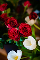 A romantic wedding bouquet featuring a mix of roses and tulips tied with a satin ribbon.