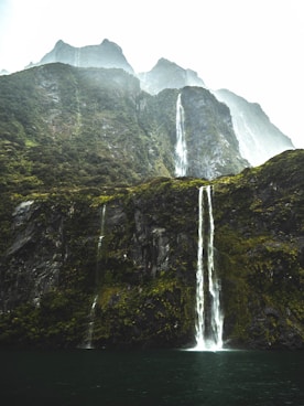 waterfalls under white sky