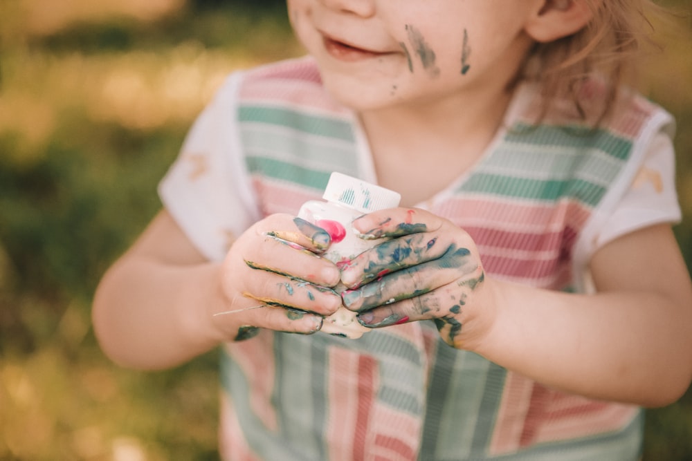 toddler holding white case