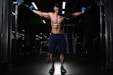 man exercising inside dim room