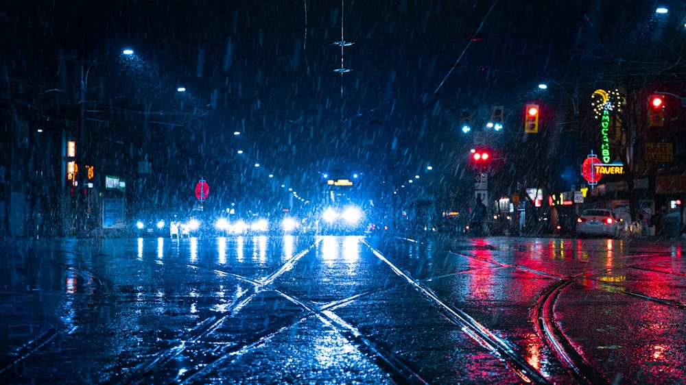 time-lapse photography of pouring rain over vehicles on road