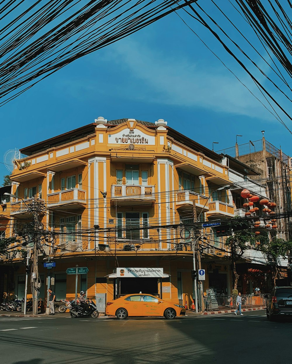 yellow taxi cab parked in front of building during day time