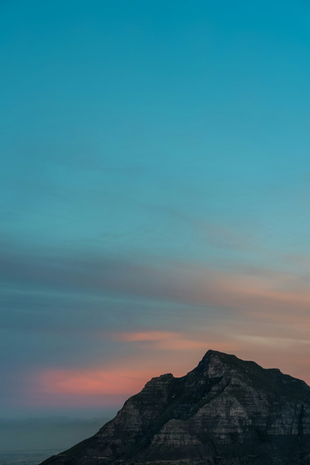 green and grey sunset sky over the rocky mountain