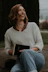 smiling woman wearing white knit sweater