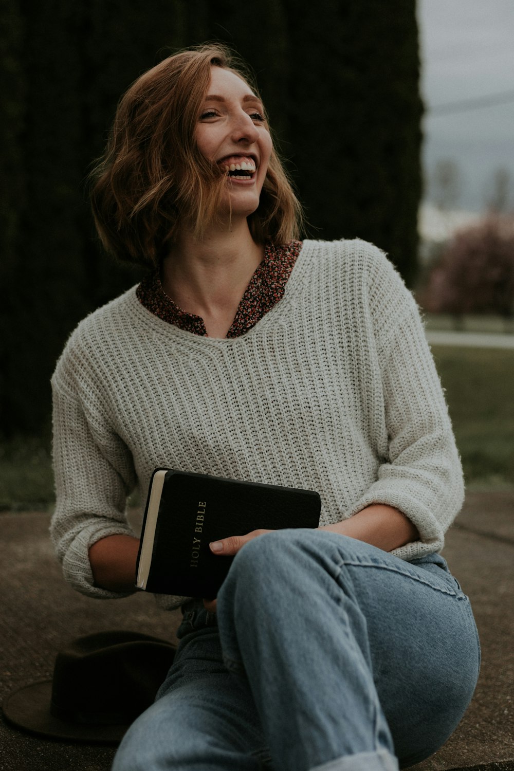 smiling woman wearing white knit sweater